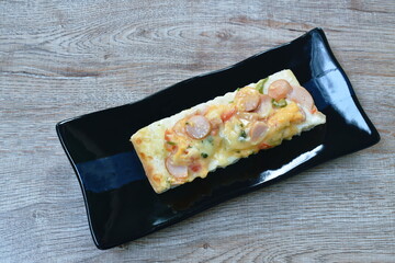 piece of pizza topping sausage and cheese on plate