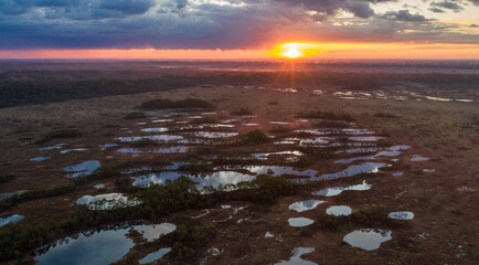 Aerial view over lake rich peat bog in the sunrise foggy morning