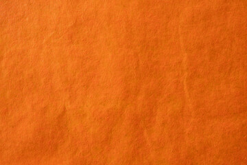 Orange crumpled paper texture background.