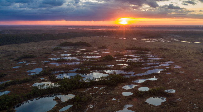 Aerial view over lake rich peat bog in the sunrise foggy morning