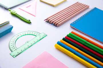 collection of bright colorful stationery on light background, close view . High quality photo