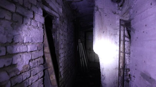 Flashlight in scary underground, basement. Old abandoned warehouses in a dungeons.