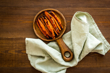 Roasted sweet potato - vegetable snack with herbs, view from above