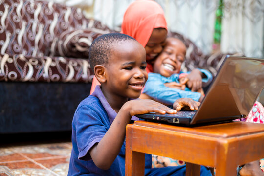 young black african preschool kid using technology having online class at home