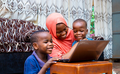 happy black african muslim single mother with two children using modem technology