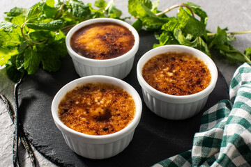 Homemade creme brulee on gray stone