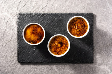 Homemade creme brulee on gray stone.Top view