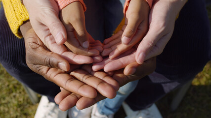 Close up of diverse family hands together outdoors
