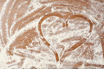 Drawn heart on the kitchen table with flour
