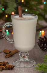 cocktail in a glass mug with a handle. selective focus. Christmas eggnog cocktail with grated nutmeg and cinnamon. Traditional holiday drink.