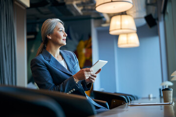 Beautiful woman using modern gadget at business center
