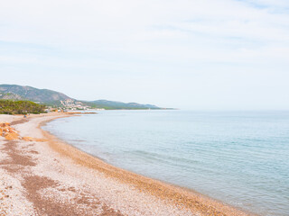 Fototapeta premium Beautiful pebble/stone beach. Paradise atmosphere with nobody. Mesmerizing coastline. Costa del Azahar, Alcossebre, Valencian community, Castellon province, Spain.