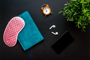 Obraz premium Reading book before going to bed. Sleeping accessories on the table, top view