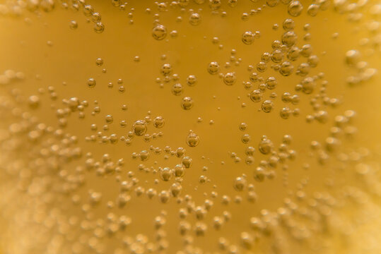 Macro photography of champagne bubbles in a glass. Selective focus. The new year is 2021.