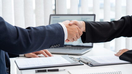 two business people shaking hands of Candidate asian businesswoman after successful negotiations or interview, career and placement concept.