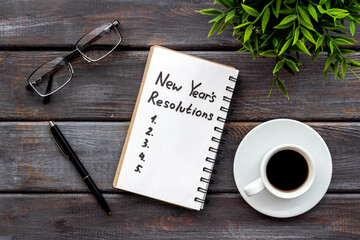 New Year's resolutions with Christmas decorations. Overhead view