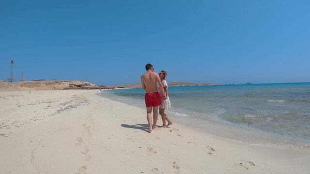 Romantic young couple on honeymoon kissing on Paradise beach at Giftun island, Egypt