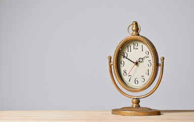 Table metal vintage clock on gray background