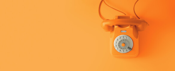 An orange vintage dial telephone with orange background. - Powered by Adobe