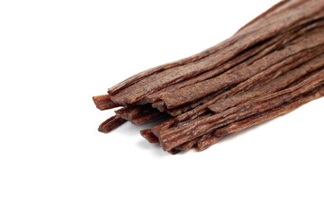 Dried beef meat sliced on stick, beer snack isolated on white background