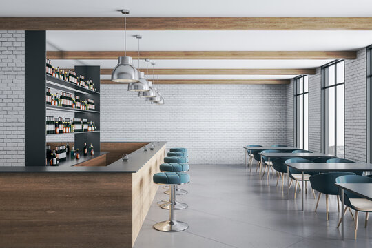 Wooden bar counter with chairs, lamps and blank brick wall.