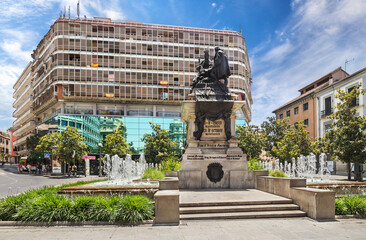 Urban square with bronze sculpture of Queen Isabella and Christopher Columbus in Granada, Spain