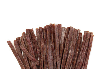 Dried beef meat sliced on stick, beer snack isolated on white background