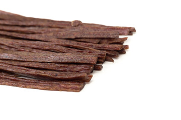 Dried beef meat sliced on stick, beer snack isolated on white background