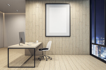 Office interior with computer, blank poster on wall and night city view.