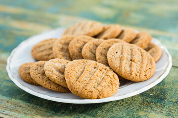 Plate of homemade cookies on rustic green paint wood table