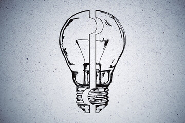 Drawing light bulb puzzle on concrete wall.