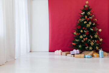 decor garland Christmas tree with gifts for the new year interior