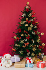 red decor garland Christmas tree with gifts for the new year interior