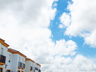 Fototapeta na wymiar facades of typical white houses against clouds sky in Medina Sidonia. Andalusia, Spain