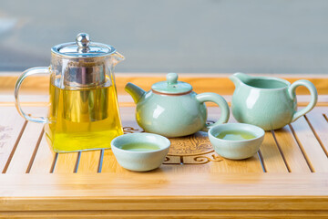 teapot,tea cup and tea leaves on a bamboo mat