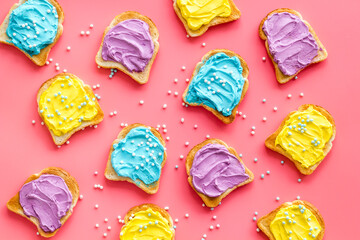 Unicorn colored toast bread slices. Food background, top view