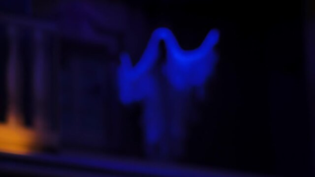4k footage ; blurry scene of simulation ghost in scared dark night shadow of old building in amusement park. background insert on Halloween party.