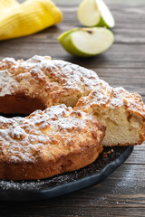 Delicious and fragrant crispy cupcake with apple pieces on a wooden table