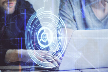 Multi exposure of data internet theme hologram with man working on computer on background. Concept of innovation.