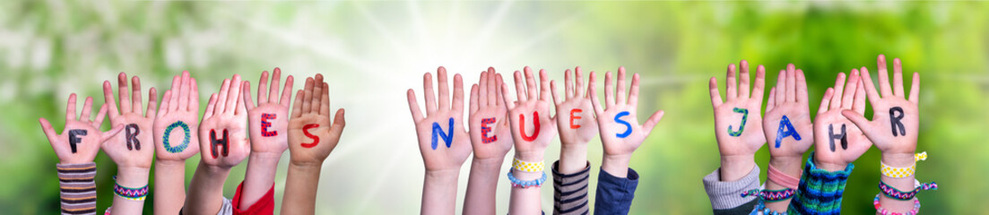 Children Hands Building Colorful German Word Frohes Neues Jahr Means Happy New Year. Sunny Green...