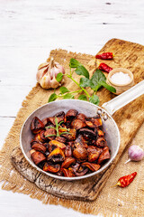 Ready to eat hot fried brown champignons in vintage pan