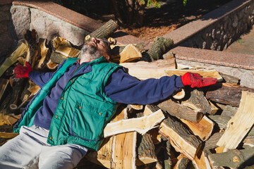 Man lying on pile of firewood