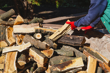 Gloved hands hold wooden log