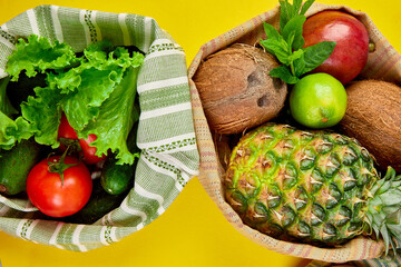 Flat lay of eco friendly grocery shopping cotton bags with organic fruits and vegetable