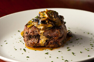 Steak dinner w/ vegetables. Traditional classical American or French Bistro main course, steak and mashed potatoes. Steak, cooked medium rare served with garlic mashed potatoes and kale salad.  