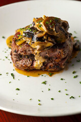 Steak dinner w/ vegetables. Traditional classical American or French Bistro main course, steak and mashed potatoes. Steak, cooked medium rare served with garlic mashed potatoes and kale salad.  