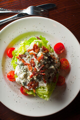 Wedge Salad. Iceberg Lettuce, blue cheese dress and shredded carrots. Classic American steakhouse or restaurant favorite. 