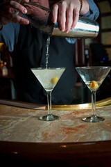 Old Fashioned Cocktail. Traditional American craft cocktails made by artisanal bartenders or mixologists in speakeasy & upscale bars or dive bar taverns. Cocktails served in chilled cocktail glass.