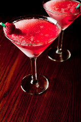 Cosmopolitan Cocktail. Action shot. Alcoholic Drinks made with gin, vodka, rum or whiskey mixed with soda water, fruit juices and garnishes with limes and cherries. Classic American bar drinks.