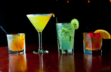 Cocktails. Traditional American drinks made by artisanal bartenders or mixologists in speakeasy & upscale bars or dives or taverns.Cocktails served in chilled cocktail glasses & garnished with fruit.